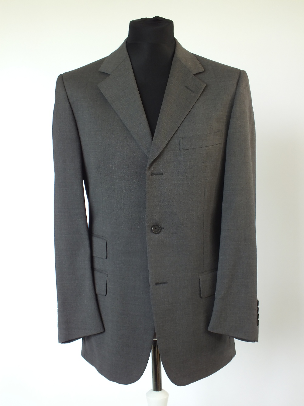 A Gucci suit, mid-grey, double vent, lined, Italian size 50R, 90% wool, 8% cashmere, 2% elastine.