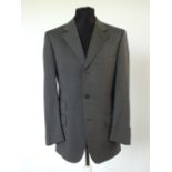 A Gucci suit, mid-grey, double vent, lined, Italian size 50R, 90% wool, 8% cashmere, 2% elastine.