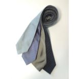 Four ties to include a navy with grey diamond spot pattern, a silver grey, a pale grey and black,