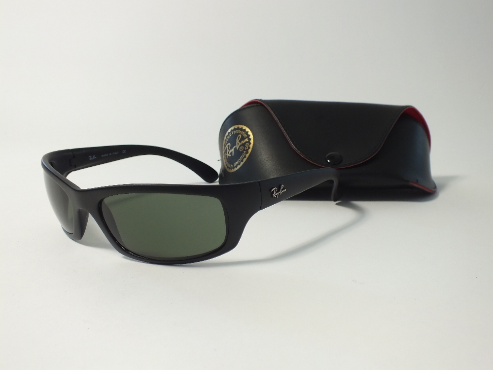 A pair of Ray Ban wrap around black sunglasses