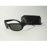 A pair of Ray Ban wrap around black sunglasses