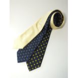 Three ties to include yellow with a white spot, blue with a yellow and white spot, blue with a