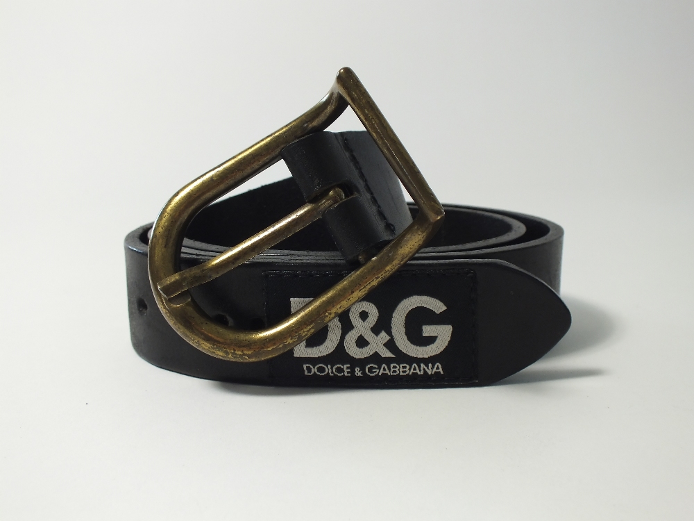 A Dolce & Gabbana black leather belt with burnished brass buckle, D&G labels along belt, size 36