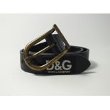A Dolce & Gabbana black leather belt with burnished brass buckle, D&G labels along belt, size 36