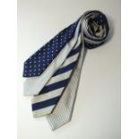 Four ties to include a white with blue spot, a woven pattern, a white, navy and silver heavy stripe,