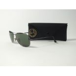 A pair of Ray Ban Aviator sunglasses in black case