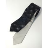 Two Gucci ties, one silver, one black with grey and silver dot diagonal pattern