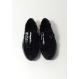 A pair of Gucci tasseled driving shoe, black patent, star and crest, silver burnished star and crest