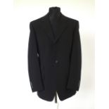 A Gucci suit , black, lined, double vented, Italian size 50R, 96% wool, 4% elastine. Flat front to