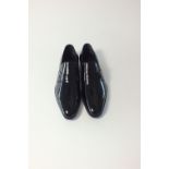 A pair of Gucci black patent slip-on loafers, small Gucci logo detail, UK 8.5