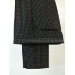 A pair of Gucci trousers, black with white square check, black satin piping detail to side seam,