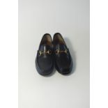 A pair of Gucci loafers, black leather classic loafer with brass horse bit detail, UK 8.5