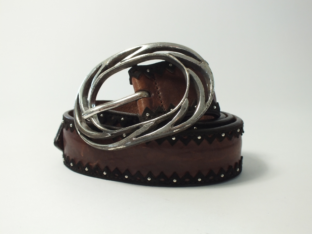 A Post and Co. brown leather belt with silver ornate oval buckle studding and leather detailing to