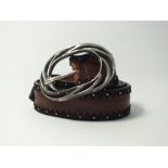 A Post and Co. brown leather belt with silver ornate oval buckle studding and leather detailing to