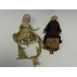 A porcelain and fabric doll house doll,