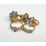 A collection of three 9ct yellow gold tanzanite dress rings,