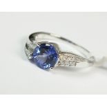 A 9ct white gold tanzanite and diamond ring with gems TV card stating carat weight of 0.