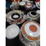 Three trays of modern Chinese and Japanese ceramics along with various stands and serving plates