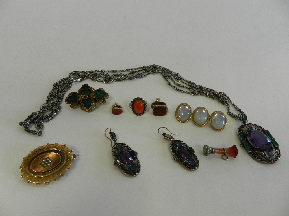 A seed pearl set mourning locket together with a malachite set brooch,