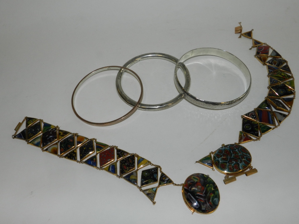 Two glass panel bracelets set in yellow metal together with two silver slave bangles and a further