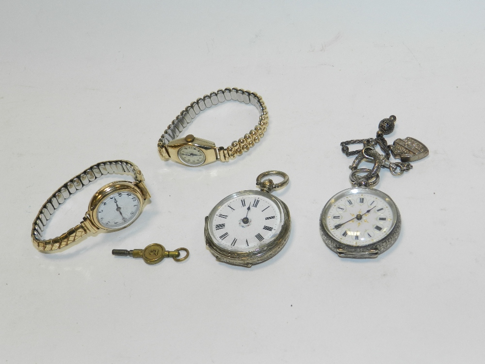 A silver open faced fob watch together with a further open faced fob watch,