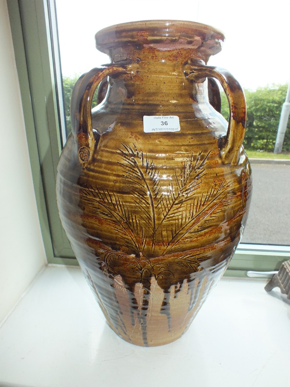 A large Wentford pottery vase by Ara Cardew of amphora shape with four strap handles and incised