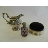 A silver mounted pin cushion together with a silver cream jug and a purple glass silver topped