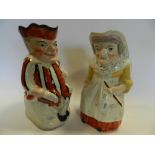 A pair of Staffordshire Toby jugs of Mr and Mrs Punch