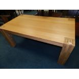 A modern oak finished particle board rectangular dining table