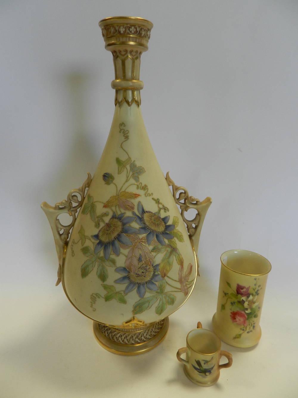 Royal Worcester blush ivory wares to include: an ovoid twin handled vase decorated with flowers and