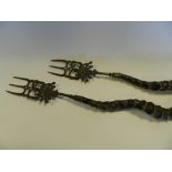 A pair of blackbuck horn toasting forks the horns mounted with South East Asian or Indian metal