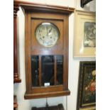 An early 20th century oak cased Vienna type wall clock together with another smaller