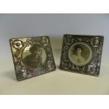 A pair of silver Art Nouveau style photograph frames decorated with poppies