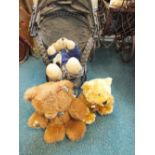 A collection of late 20th century teddy bears together with two vintage dolls' prams