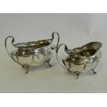 A silver sugar bowl with matching cream jug hallmarked 'Chester'