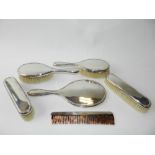 A set of silver backed dressing table wares to include four brushes,