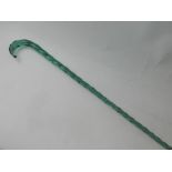 A wrythen moulded green glass cane