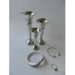 A graduated suite of three silver mounted posy vases together with two bangles and a silver ring