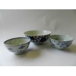 Three Chinese blue and white bowls decorated with lotus flowers,