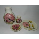 Two Moorcroft Magnolia pattern vases together with two Moorcroft Magnolia pattern dishes