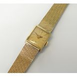 A Lady's gold plated Omega bracelet watch, the rectangular champagne dial with batons, manual wind,