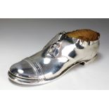 An Edwardian novelty silver mounted pin cushion in the form of a shoe, makers mark rubbed,