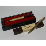 A rolled gold retracting pencil together with a Rite Point Cunard White Star Line Queen Elizabeth
