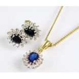 An 18ct gold sapphire and diamond oval cluster pendant, suspended from gold plated chain,