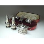 A pair of silver pepperettes, Chester, together with a silver mustard,