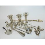 A silver tea strainer together with a further silver tea strainer,