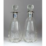 A pair of silver mounted glass decanters, Hammond, Creake & Co, Sheffield 1924,