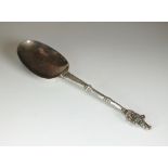 A white metal spoon, with figural terminal and knopped stem, 18.5cm long, weight 1.