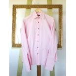 A Gucci shirt, pink, with black buttons,