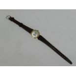 A lady's yellow metal Rotary wristwatch, the silvered dial with batons, manual wind,